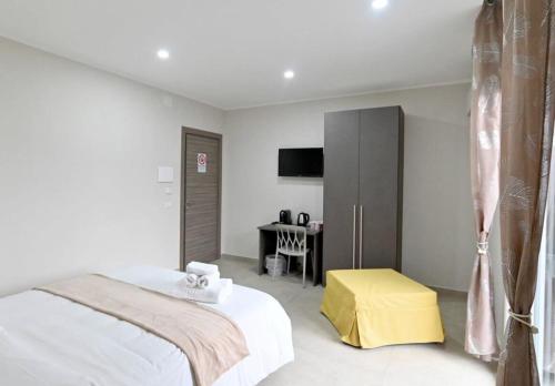 a white bedroom with a bed and a desk at Coast To Coast - Rooms & Pool! Camere moderne e piscina in Sant'Egidio del Monte Albino