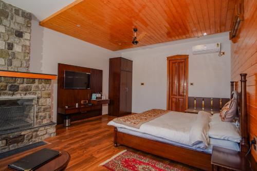 a bedroom with a bed and a fireplace at Neelesh Inn- A Luxury Lake View Hotel- 20 kms from Nainital in Bhīm Tāl