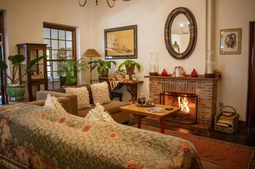a living room with a bed and a fireplace at 5 Seasons Guest House in Stellenbosch