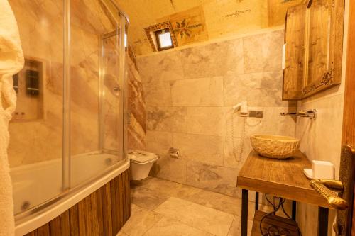 a bathroom with a shower and a sink and a tub at Walnut House in Goreme