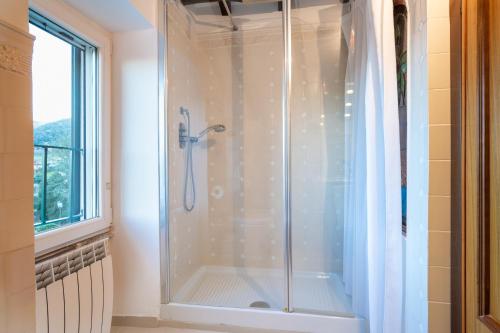 a shower with a glass door in a bathroom at TENUTA CAVI 6&4, Emma Villas in Colleferro