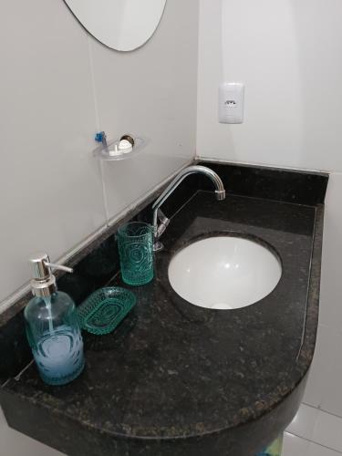 a bathroom counter with a sink and a faucet at Quarto Sol Nascente in Tianguá