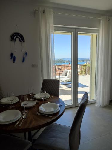 a dining room with a table with plates and wine glasses at ELEVEN in Šibenik