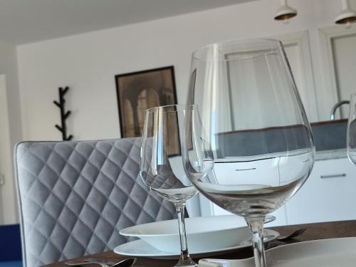 two wine glasses sitting on top of a table at ELEVEN in Šibenik