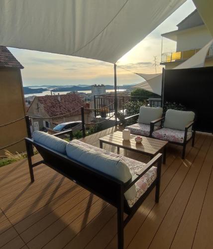 a balcony with a couch and a table on a deck at ELEVEN in Šibenik