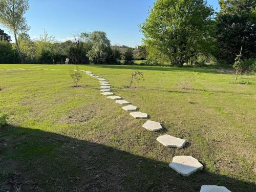 a path in a field with rocks in the grass at Tiny village de Sault in Prémilhat