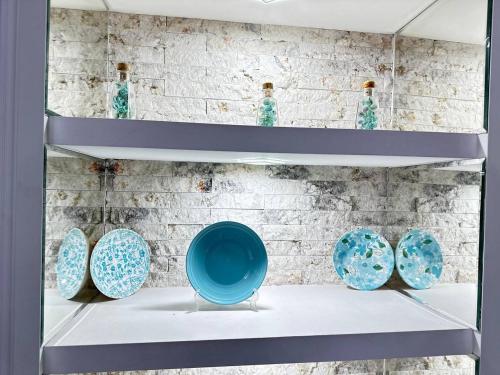 a shelf with four blue bowls on it at Apartment in old Tbilisi in Tbilisi City