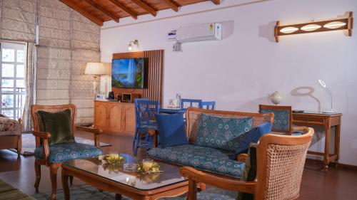 a living room with a couch and chairs and a table at Neelesh Inn- A Luxury Lake View Hotel- 20 kms from Nainital in Bhīm Tāl