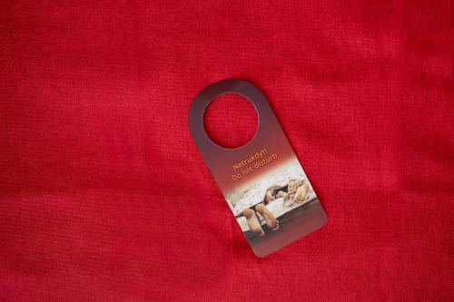 a black ribbon with a book on a red background at Art City Inn in Vilnius