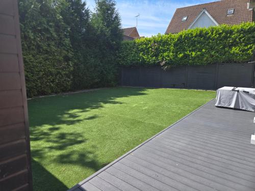 a backyard with a lawn with a table on it at Newly Built Studio Apartment in Weston