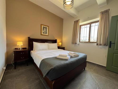 a bedroom with a bed with two towels on it at 1bed Mel Apt W Church Views By Homely Malta! in Mellieħa