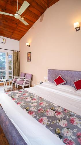 a hotel room with a large bed and a couch at Neelesh Inn- A Luxury Lake View Hotel- 20 kms from Nainital in Bhīm Tāl