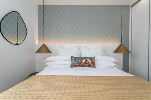 a bedroom with a large bed with a large mirror at GuestReady - Elegant Marina Apartment in Ponta Delgada
