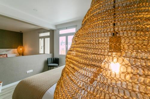 a bedroom with a bed with a large bedspread at GuestReady - Elegant Marina Apartment in Ponta Delgada