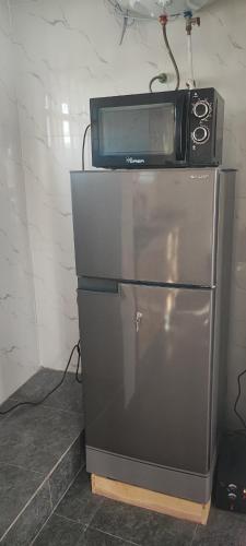 a microwave sitting on top of a refrigerator at Résidence Yemissi in Cotonou