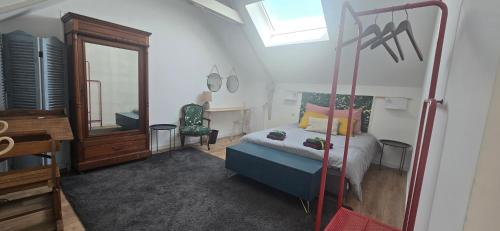 a bedroom with a bed and a mirror at Gîte avec sauna in Vigneux-de-Bretagne