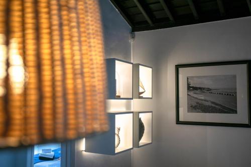 a wall with pictures on it with a window at GuestReady - OceanFront Lookout House in Ponta Delgada