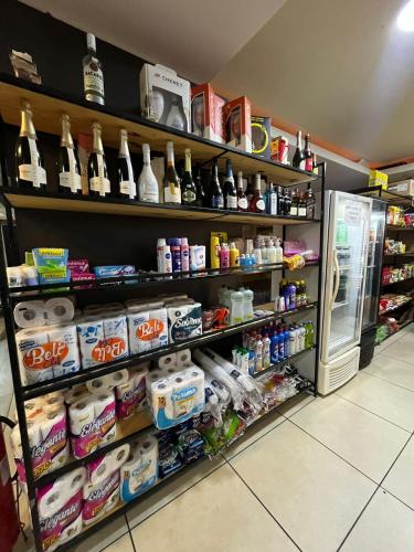 a grocery store aisle with a refrigerator and lots of food at Golden Lake - Lindo Apartamento com Lagoa Privativa in Arraial do Cabo