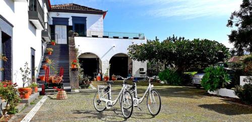two bikes parked in front of a house at Ninho do Cedro - Azorean tranquility in Ponta Delgada