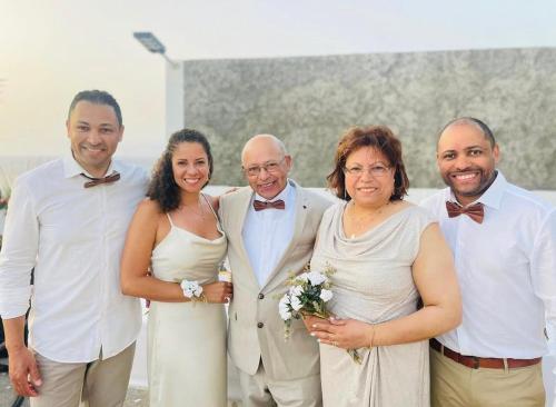 a group of people posing for a picture at a wedding at Fogo Boutique Hotel in São Filipe