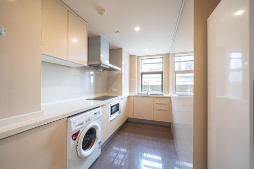 a kitchen with a washer and dryer in it at Tonight Homestay South Shanxi Road Shanghai in Shanghai