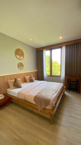 a bedroom with a large bed and a large window at 2 Bedroom Villa In Sanur Harbour in Sanur