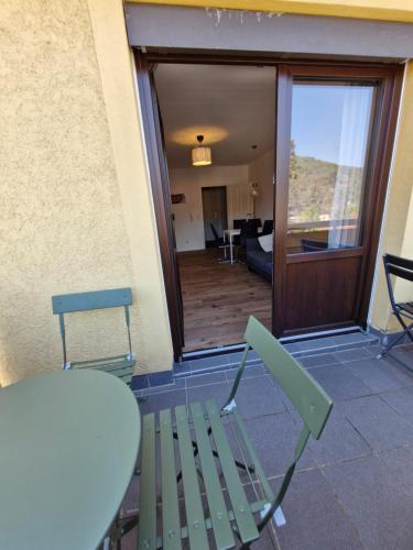 a table and chairs on a patio with a view of a room at Altstadtblick in Heidelberg