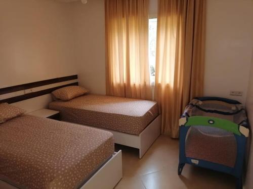 Postel nebo postele na pokoji v ubytování Appartement familial avec piscine Imi Ouaddar