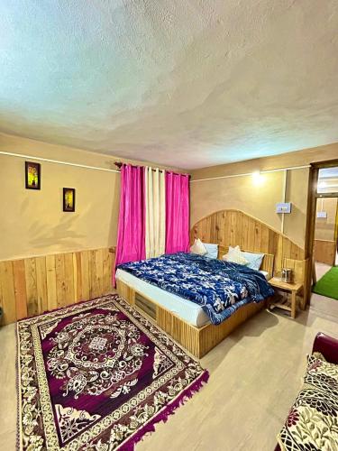 a bedroom with a bed and a rug at Alpine Stays Riverside in Jibhi