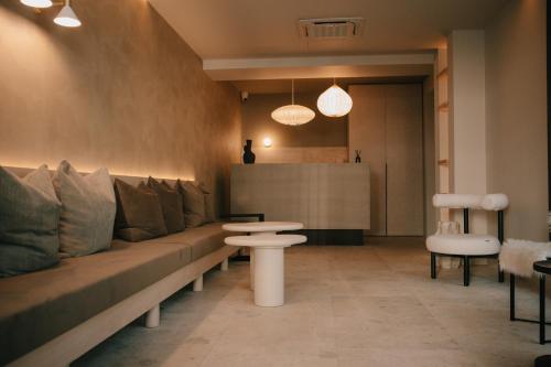 a long couch with pillows and a table in a room at Alinea Lano Old Town Center in Limassol