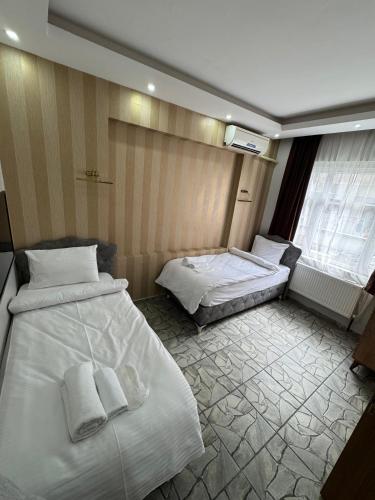 a hotel room with two beds with towels on them at beyzade apart hotel in Istanbul