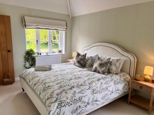 a bedroom with a bed with two cats on it at Roost in Heyshott in Midhurst