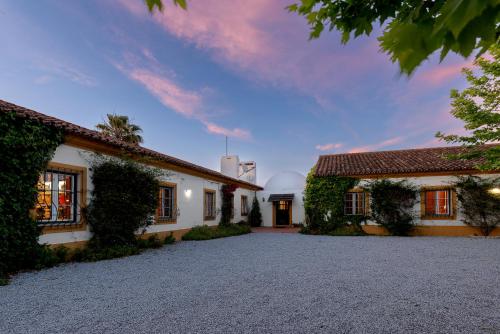an exterior view of a house with a driveway at Courela da Azinheira - Country Guesthouse in Lavre