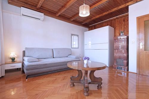 a living room with a couch and a table at Apartments Villa Flamingo in Makarska