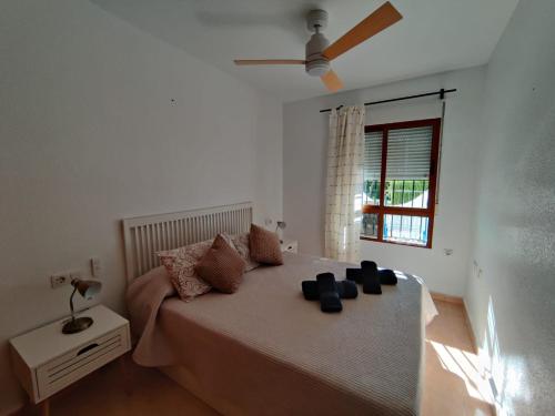 a bedroom with a bed with a ceiling fan at Apartamento LISA in Bolnuevo