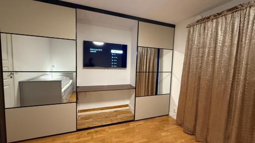 a room with a large white closet with a tv at Villa South Beach in Karlskrona
