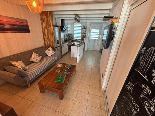 a living room with a couch and a coffee table at Villa Pétrel in Saint-Paul
