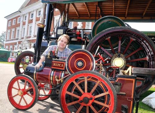 a man is sitting in an old train engine at The Bungalow and Studio Apartments in Lytham St Annes
