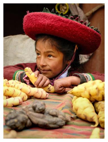 a young girl wearing a sombrero holding a banana at Casa de Gumercindo in Ccorcor