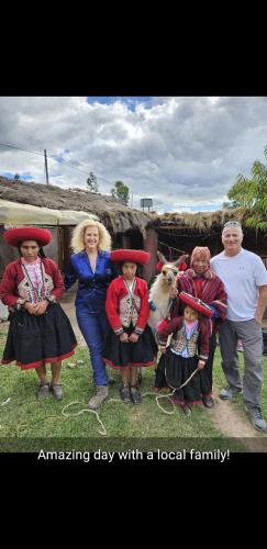 a group of people posing for a picture with a local family at Casa de Gumercindo in Ccorcor