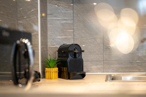 a hair drier sitting on a counter next to a sink at Diamond Apartments 3 in Kardamaina