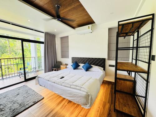 a bedroom with a king sized bed and a staircase at AYD-IN BY GREENLEAVES Resort in Vythiri