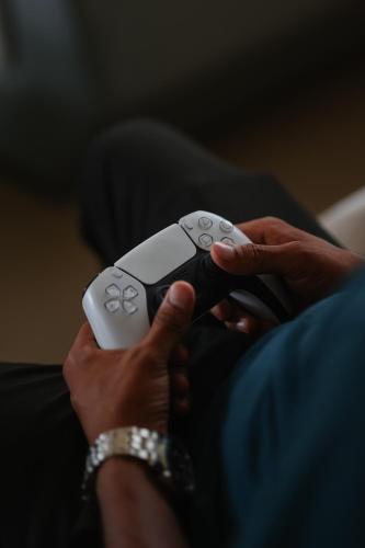 a person holding a nintendo wii game controller at Radisson Resort Hatgad Saputara in Saputara