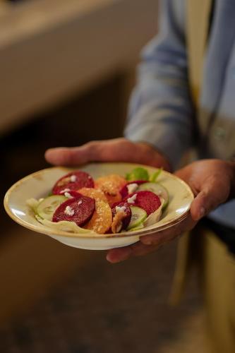 a person is holding a plate of food at Radisson Resort Hatgad Saputara in Saputara
