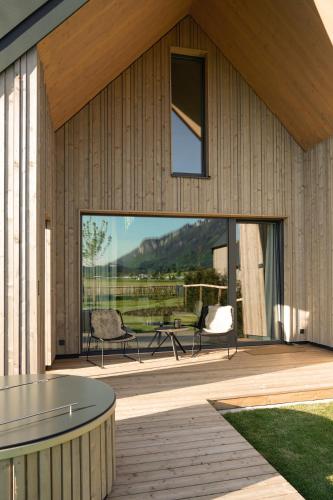 a house with a patio with a table and chairs at Agrad Chalets in Aschau im Chiemgau