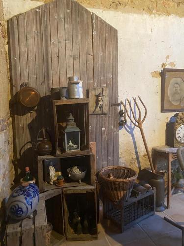 a room with wooden shelves with pots and pans at chambre d hôtes Ferme Bressane la barcarolle in Dommartin-lès-Cuiseaux