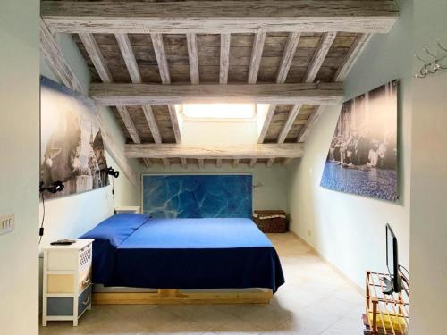 a bedroom with a blue bed and a wooden ceiling at Piazza Di Spagna Prestige in Rome