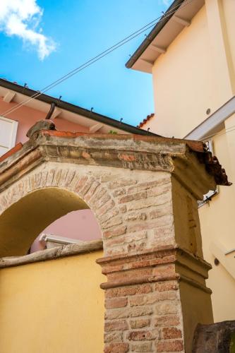 an archway on the side of a building at L' ΛᄂᄂӨGGIӨ di KΛMΛ' in Cesena