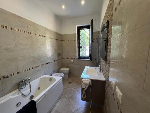 a bathroom with a tub and a sink and a toilet at Free parking - 5 min from bus stop - excellent apartament in Rome