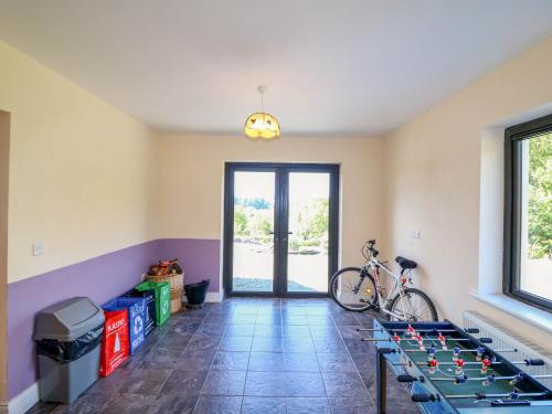 a room with a ping pong table and a bike at Curraha in Kenmare